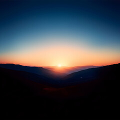 Fototapeta premium Vibrant Sunset Over Silhouetted Mountains