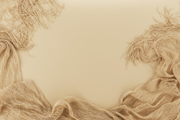 Space for text surrounded by lacy shiny fabric. Flowing shiny fabric and background for text in beige toning.