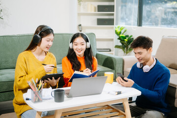  Group of young adults in casual wear, using laptops and headphones, enjoying teamwork, creativity, and learning