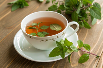 A teacup with tulsi tea and fresh leaves