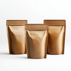 Obraz premium Three gold foiled bags on white background showcasing sustainable packaging isolated for product display