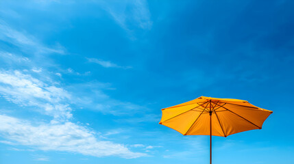 Yellow Beach Umbrella Under a Vivid Blue Sky