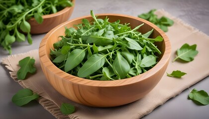 Fresh green arugula leaves on wooden bowl isolated on white background