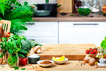 Healthy eating, cooking, food blogging background. Empty oak cutting board with mushrooms, tomatoes, lettuce, vegetables on cozy kitchen with wooden table, kitchenware and utensils