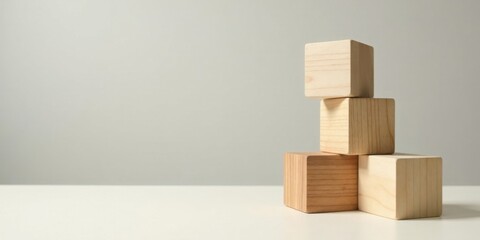 Simple Wooden Blocks Arranged in a Stack on a White Surface Against a Neutral Background