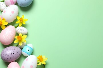 Happy Easter. Colorful eggs and yellow flowers on a pastel color background, space for text or advertising