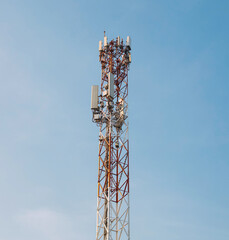 Mobile phone signal towers, white and red internet on a clear day