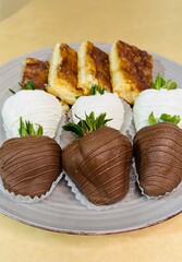 Chocolate covered strawberries and churro cheesecake. Brown and white