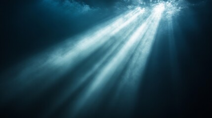 Bright rays of light pierce through a dense, dark atmosphere, creating an ethereal glow that contrasts sharply with the surrounding shadows. This phenomenon inspires feelings of calmness and wonder