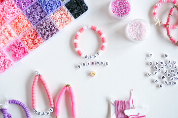 Diy friendship bracelets and beads on the table close up.