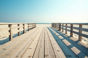 Obraz premium Wooden boardwalk path leading to a tranquil ocean beach on a sunny day