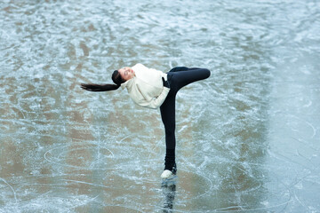Figure skater girl on winter lake.