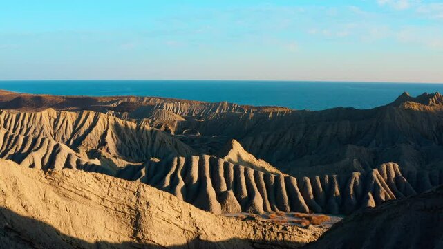 Aerial view of desert with unique rock formations and a sea in Hingol Balochistan National Park