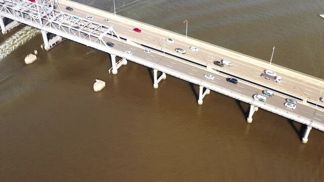Parramatta river surface to distant City of Sydney CBD skyline in aerial view as 4k.
