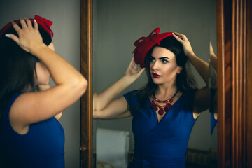 Lady in red hat fixing hat