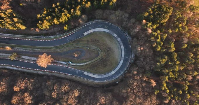 Aerial view of Caracciola Karussell corner at the Nurburgring with colorful autumn trees