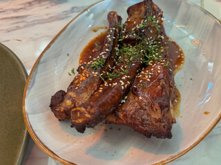 Crispy pork belly slices served with salad and Vietnamese fish sauce.