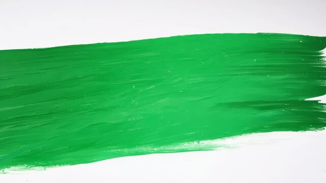 Green paint brushstroke on canvas progression: smooth artistic motion unfolds
