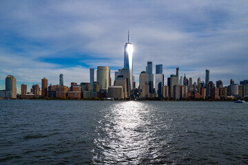 Naklejka premium New York City skyline. NYC skyscrapers reflections in water. Manhattan skyline over Hudson River. NY cityscape. Downtown New York buildings. NYC skyline. View of NYC skyline. Hudson and Manhattan.