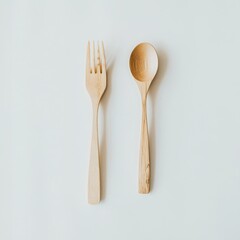 Polished wooden dining spoon and fork set placed on a light background, perfect for eco-friendly dining experiences