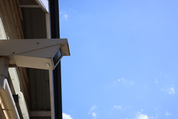 surveillance camera under the roof and blue sky
