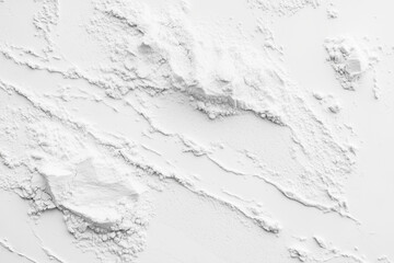 white background with a white powdery substance on it. The powder is spread out in a way that it looks like it's been blown away. The image has a somewhat chaotic and disorganized feel to it