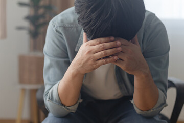 The young man, grieving to the point of almost despair, sat on a chair in his house, his shoulders hunched, and stared at the floor, immersed in a sea of ​​sorrow.