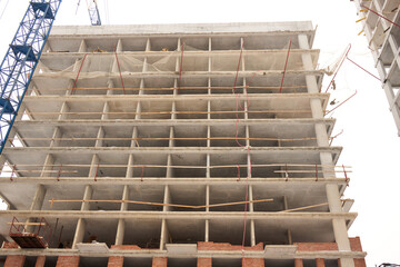 A bustling Construction Site showcasing Cranes, Building Framework, and full activity all around