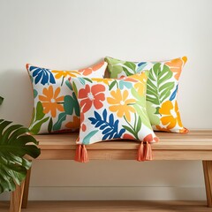 Bright floral-print pillows with tassels, styled on a sunny wooden bench