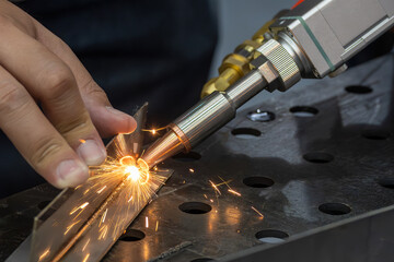 Close up scene the portable laser welding machine operation. © Pixel_B