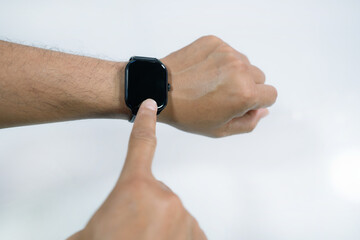 male hand wearing smart watch with blank screen on white background.Wearable technology concept.