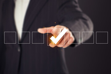 Businessman hand touching to tick correct sign mark on checkbox from checklist , Business selection...