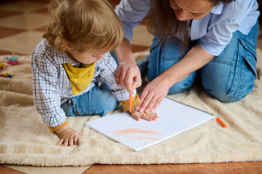 Mother and Child Engaged in Creative Drawing Activity During Leisure Time