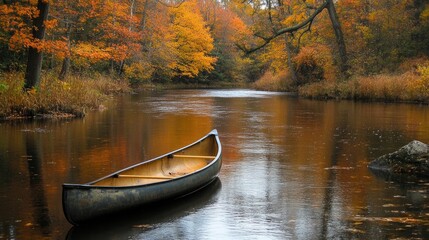 Obraz premium A scenic canoe floating on a calm river surrounded by autumn foliage