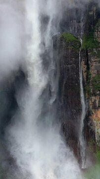 Angel Falls waterfall through the clouds. Close up of a huge flow of water falls from the mountain. The tallest uninterrupted waterfall in the world. Canaima National Park, Venezuela