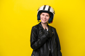 Young English woman with a motorcycle helmet isolated on yellow background giving a thumbs up gesture