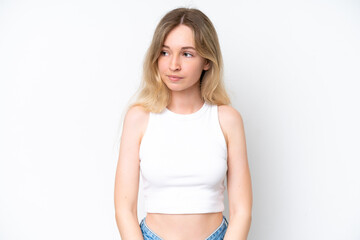Blonde English young girl isolated on white background making doubts gesture looking side