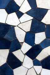 A layered, puzzle-like arrangement of soft-edged polygons in contrasting whites, grays, and rich