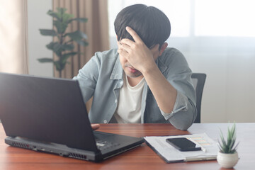 Feeling stressed and exhausted, he sat at his desk in the office, struggling to focus as the weight of his workload pressed down on him.