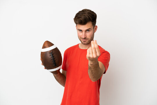 Young caucasian man playing rugby isolated on white background making money gesture