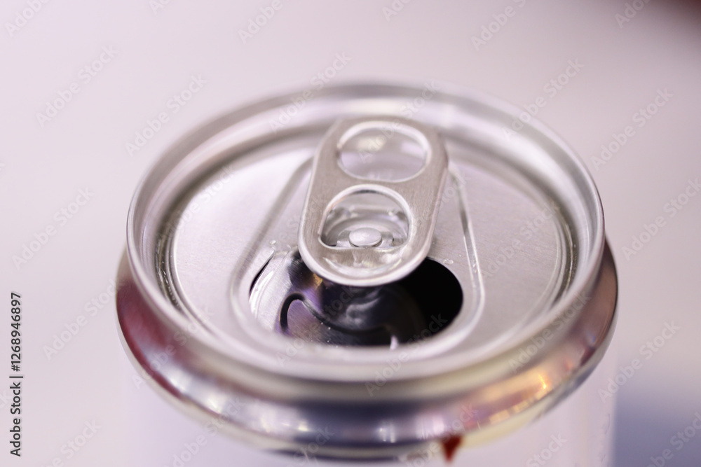 Poster a close-up photo of a soda can with label and design details.