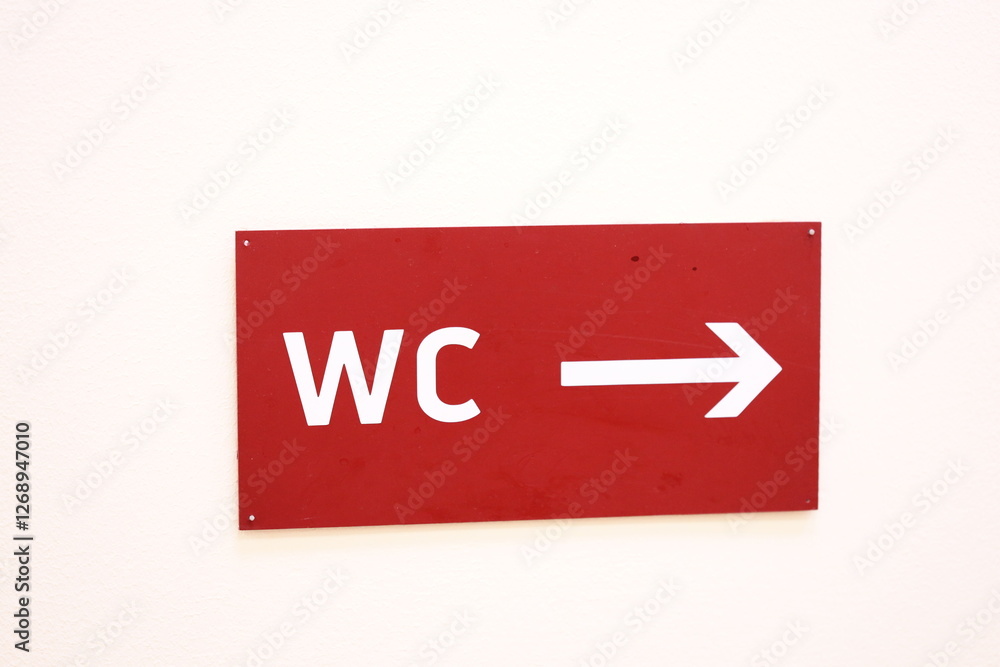 Poster A red sign with an arrow pointing to the right direction.