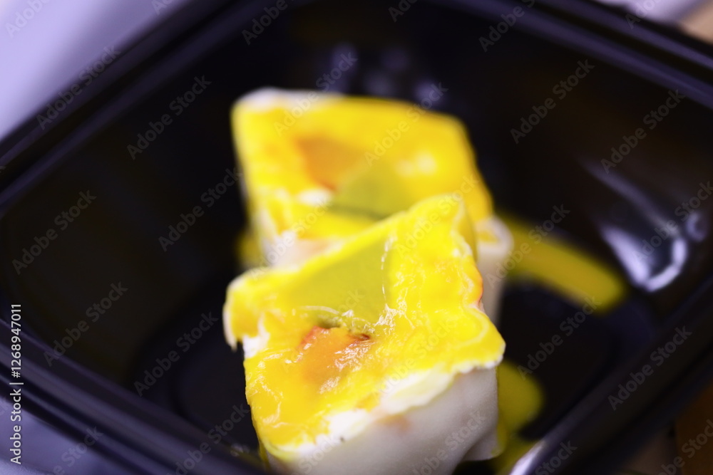 Poster a close-up shot of food in a plastic container, suitable for use in articles about meal prep or food