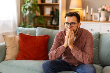 A portrait of a man with a worried expression, conveying a sense of concern or uncertainty....