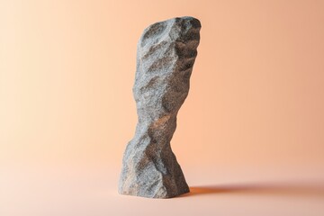 Single sculpted granite rock stands prominently against an orange background