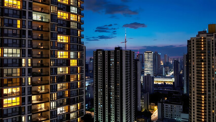 Cityscape of tall buildings at dusk with a vibrant blue sky, representing urban living, modern architecture, and the beauty of city skylines in evening lights