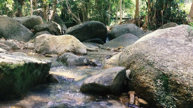 A small mountain stream among the rocks in the jungle