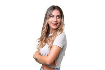 Young Uruguayan woman over isolated background looking to the side and smiling