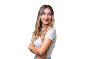 Young Uruguayan woman over isolated background looking to the side and smiling