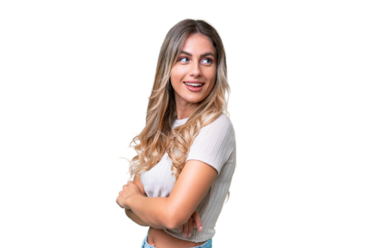 Young Uruguayan woman over isolated background looking to the side and smiling